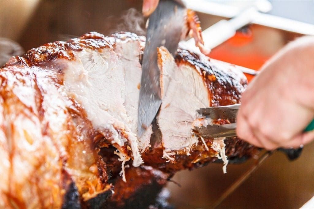 A chef carving the hog roast