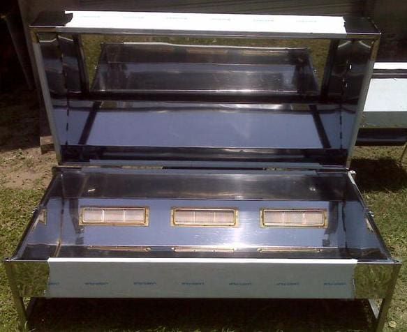Inside the machine: three ceramic burners under a polished steel lid
