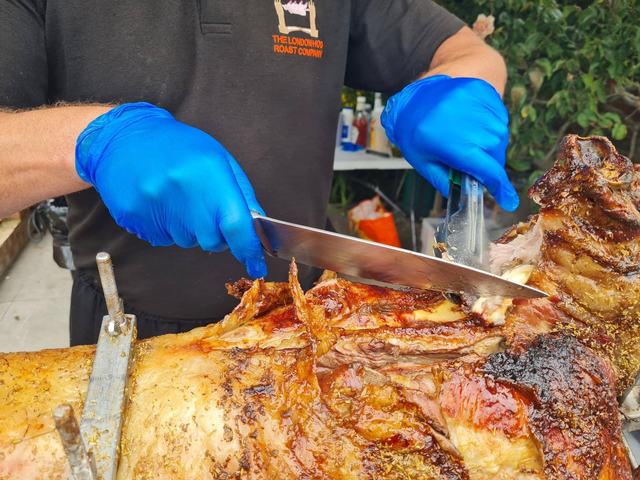 Carving charcoal-roasted lamb
