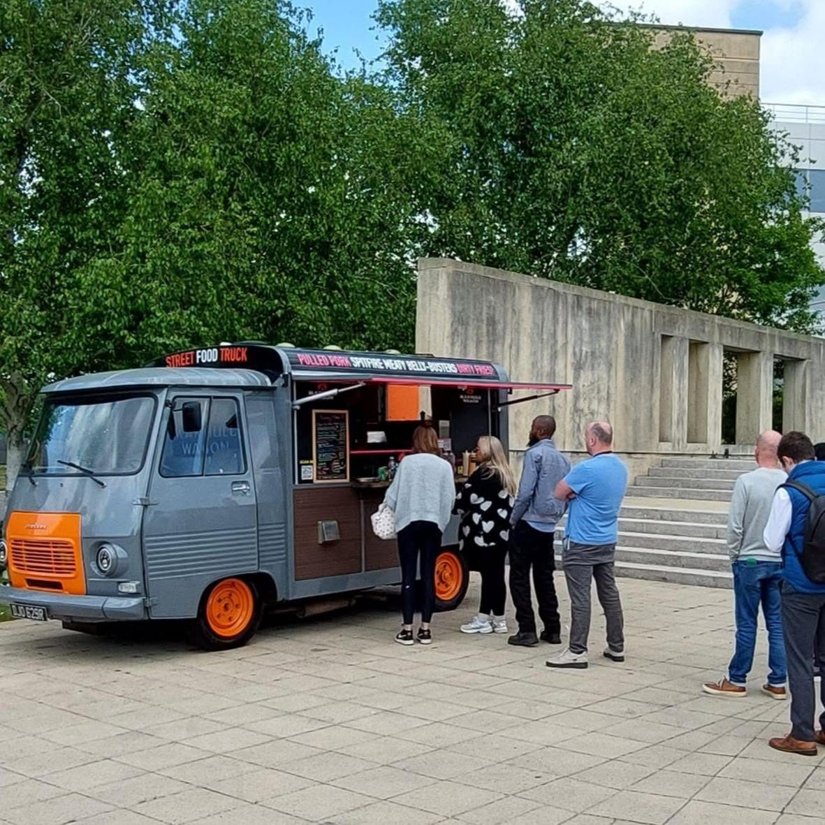 Office staff queueing at the Makhulu Wagon on a business campus at lunchtime