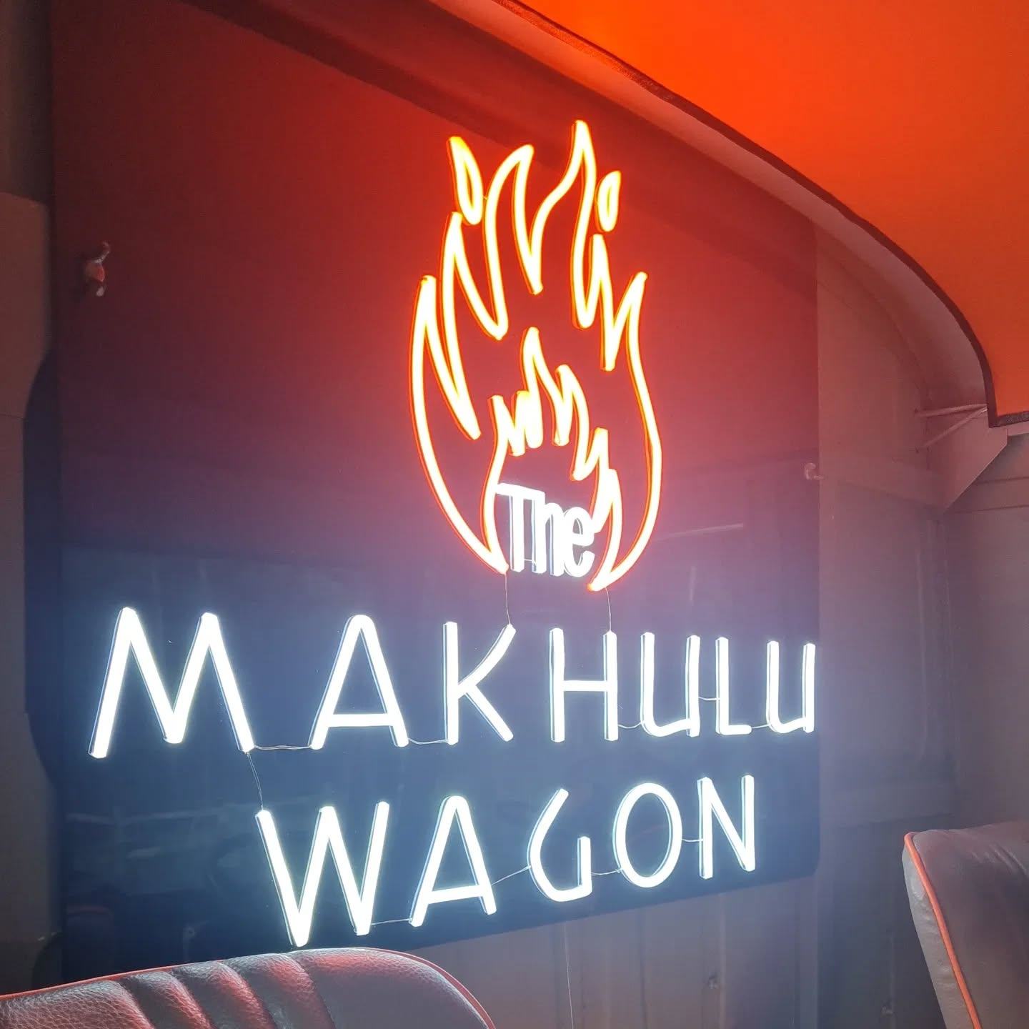 The Makhulu Wagon neon sign glowing inside the truck