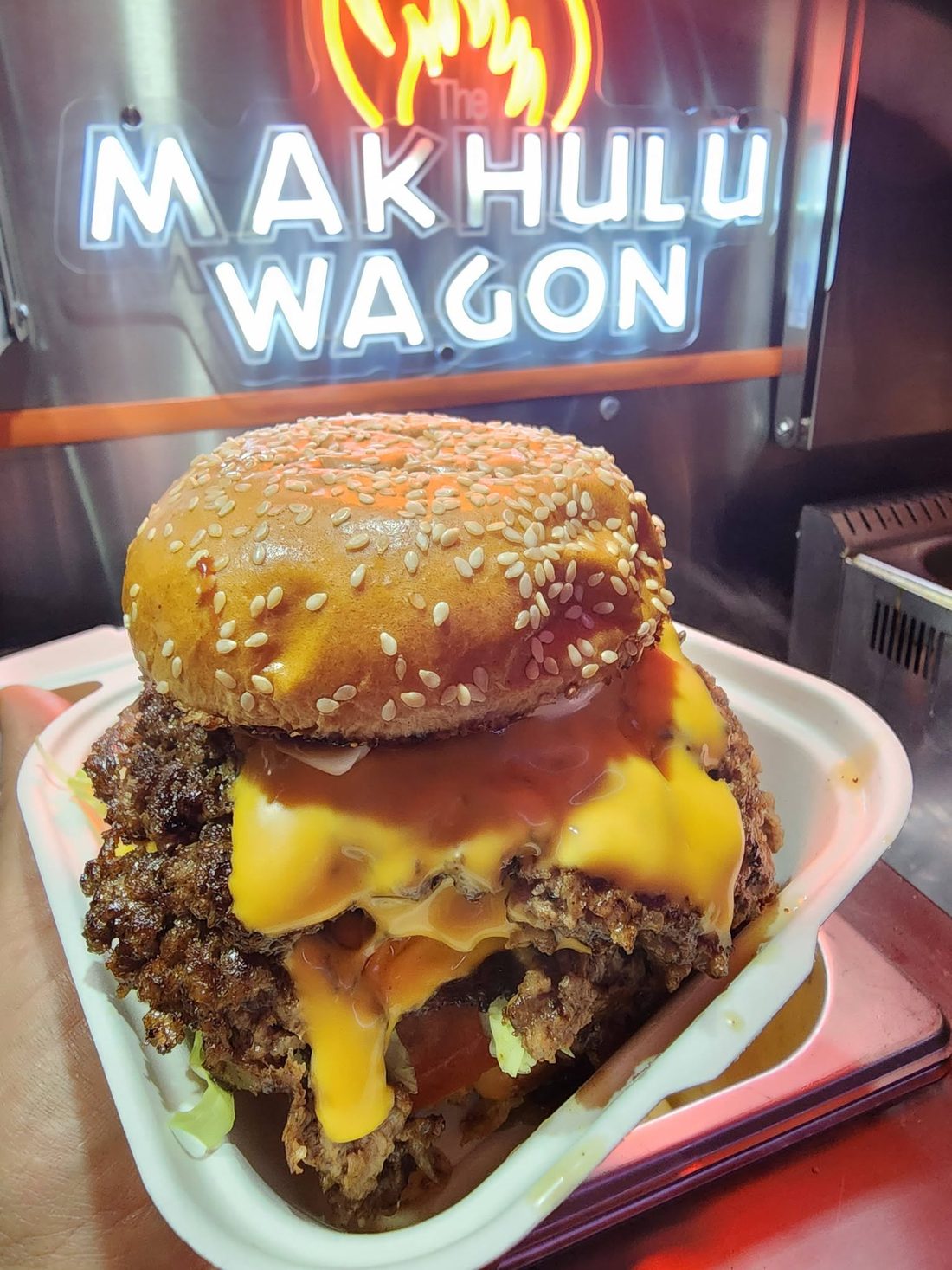 Smash burger with melted cheese in a takeaway box