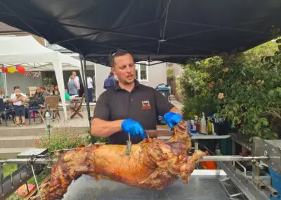 lamb roasting on charcoal carved by professional roast chef.