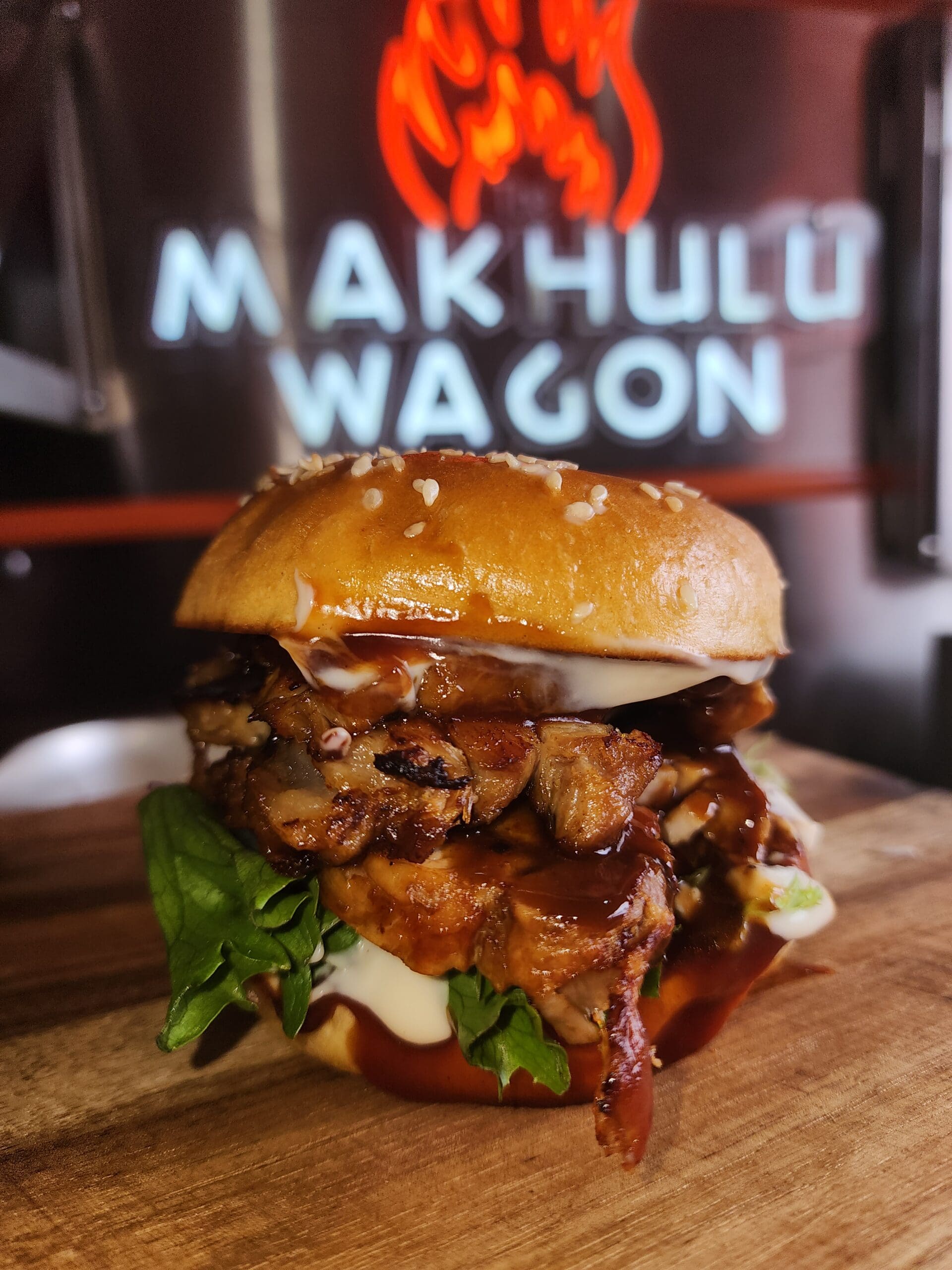 pork loin belly buster roll with lettuce, tomato, red onion and sauces